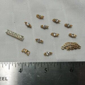 Set of vintage parts: 10 connector rings with rhinestones, one feather with rhin